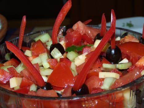 Tasty salad with tomatoes, olives, cheese, pepper, cucumber and olive oil.