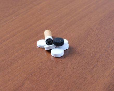 cigarette and tablets on table