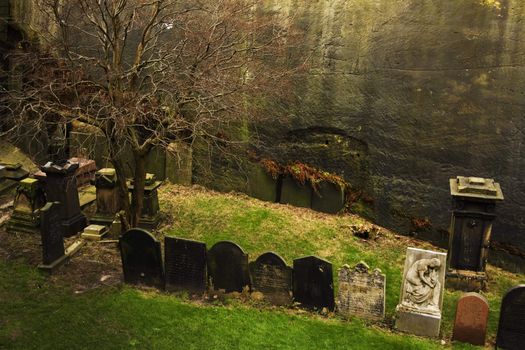 Row of very old tombstones in a cemetery