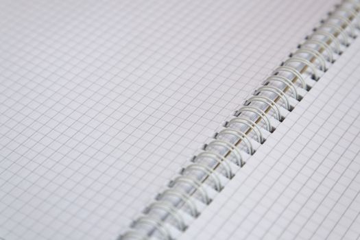 A spiral-bound notebook of squared graph paper.