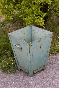 old rusty recycle bin in a park