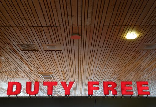 Red sign at an airport, reading "Duty Free"
