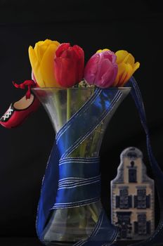 several dutch symbols, tulips, traditional shoes and typical house in white and blue