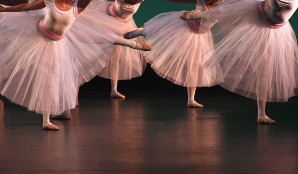 Ballet dancers balancing on stage