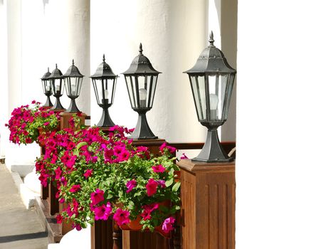Row of black street lamps against the white columns