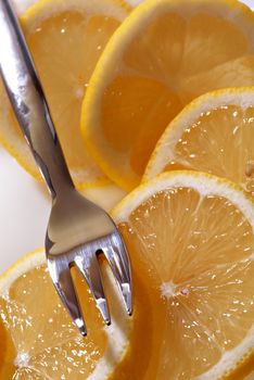 The cut slices of a lemon on a dessert plate. A close up.