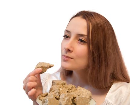 a girl eating tasty halavah. Isolated on white