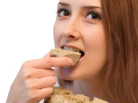 a girl eating tasty halavah. Isolated on white