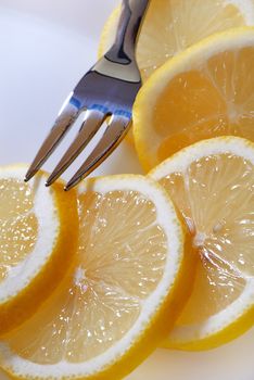 The cut slices of a lemon on a dessert plate. A close up.
