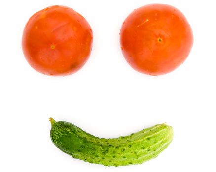 Abstract vegetable smile. Tomatoes and a cucumber on a white background.