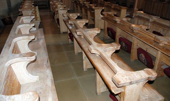 A photograph of rows of pews inside a Cathedral