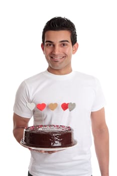 Smiling man holding a chocolate birthday cake