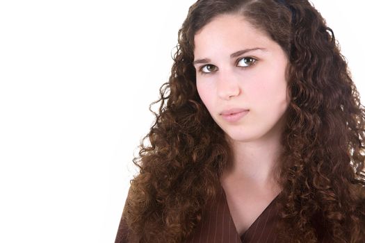 Beautiful young girl with brown curly hair. Isolated on white background.