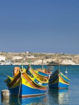 Traditional fishing boats of Malta in the fishing village of Marsaxlokk