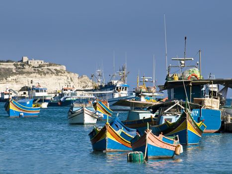 Traditional fishing boats of Malta in the fishing village of Marsaxlokk