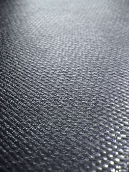 Real carbon fiber in its raw form - this material is used to make durable and strong parts for cars, boats, bikes, and even photography equipment. Shallow depth of field.