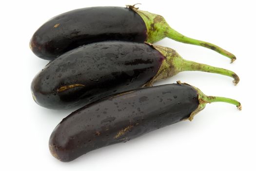 Three big eggplants on a white background.