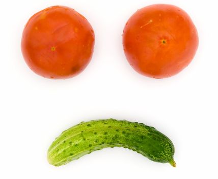 Abstract vegetable face. Tomatoes and a cucumber on a white background.