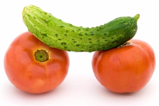 Tomatoes and a cucumber on a white background.