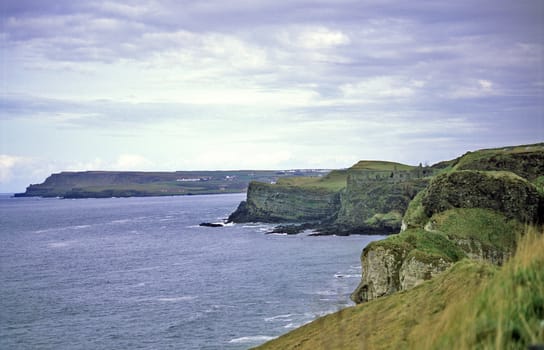 The ruins of Dunluce castle are visible on the cliffs of Northern Ireland's rocky coast.