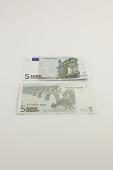 Front and back of two 5 Euro bills on a white background
