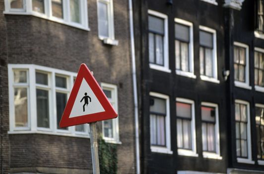 A caution sign in Amsterdam depicts a man walking with one leg missing.