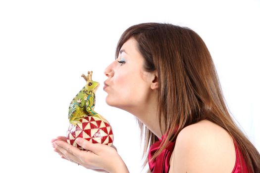 Young woman kissing a frog king and hopes for her prince