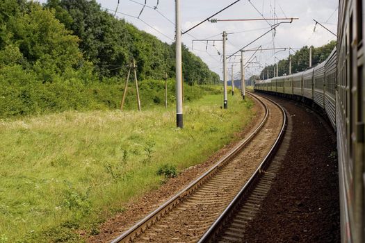 Passenger train in low motion at summer time. Russia.