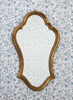 Golden Mirror Frame on Wall with Victorian Wallpaper