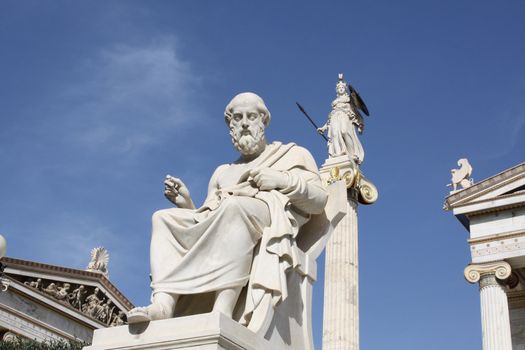 Neoclassical statues of ancient Greek philosopher Plato and goddess Athena outside the Academy of Athens. One of the major landmarks of Athens, Greece.