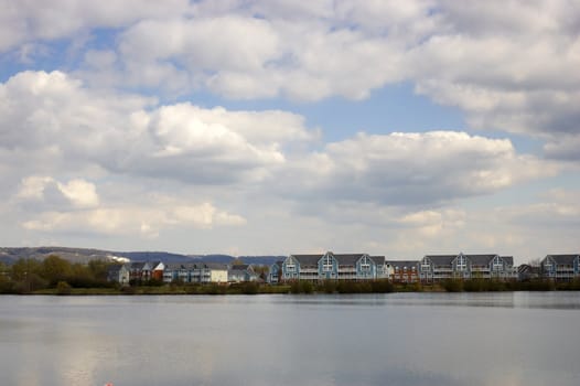 A lake with some wooden clad homes