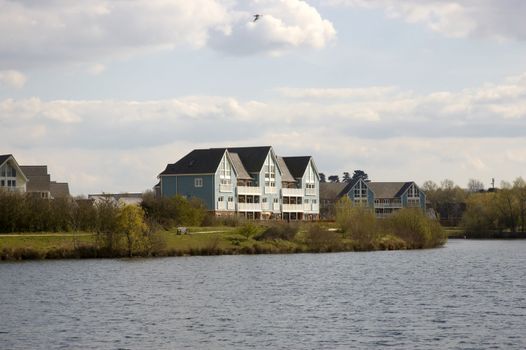 A lake with some wooden clad homes