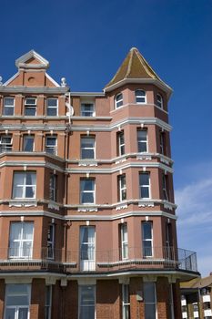 A row of victorian townhouses with a blue sky