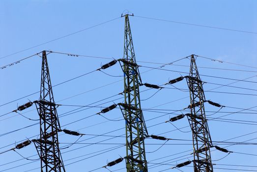 Support of an electricity transmission on a background of the clear blue sky.