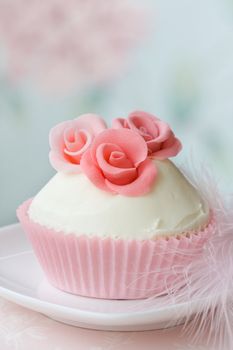 Cupcake decorated with pink sugar roses