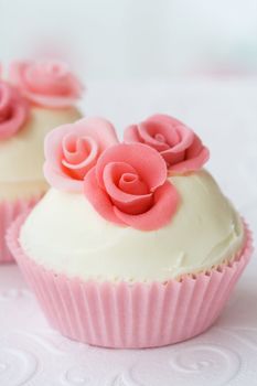 Cupcake decorated with pink sugar roses