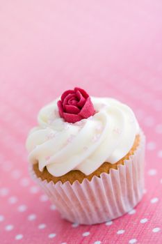 Mini cupcake decorated with a sugar rose