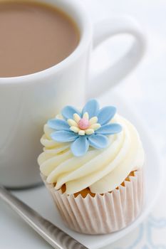 Coffee and cupcake on a white plate