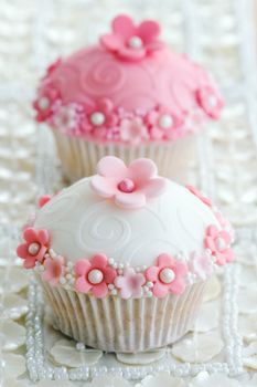 Wedding cupcakes decorated with a pink and white theme