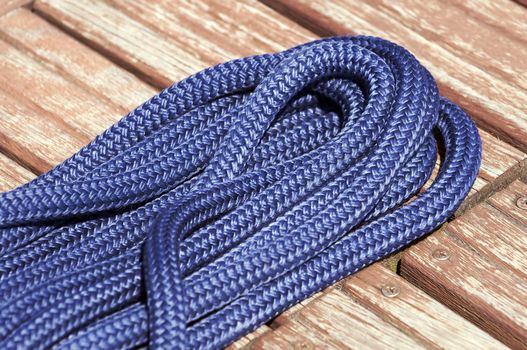 Close-up of a blue rope on a wooden jetty