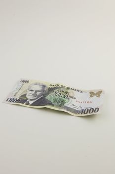 A one thousand Jamaican dollar bill with a white background