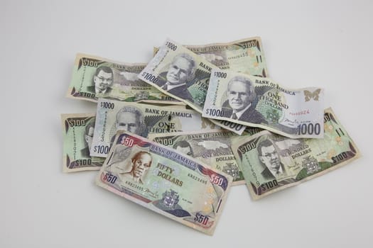 A pile of Jamaican money with a white background