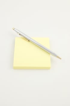 Pen on a yellow sticky pad