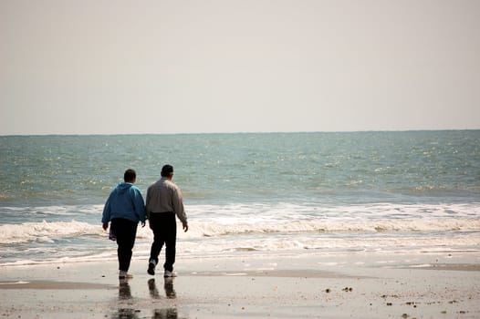Older Couple Walking On The Beach