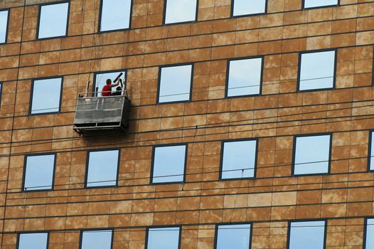 Photo of process of washing of windows at the big height.