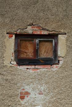 Window in the destroyed wall of the old thrown house