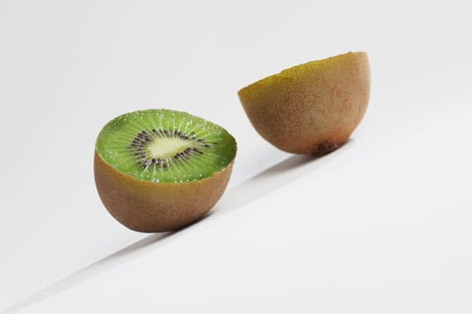 Kiwi sliced in half against a white background.