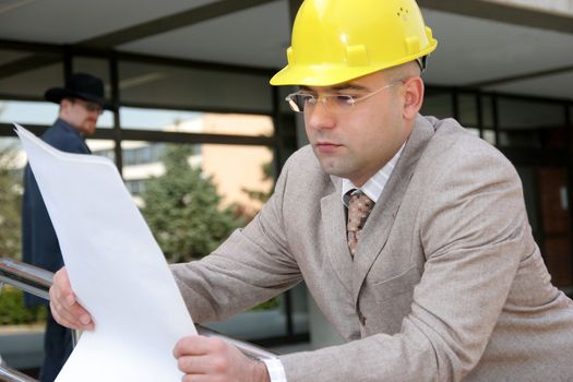businessman with architectural plans