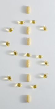 Pills in the shape of a dollar sign, against white background.