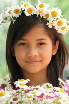 Little girl with crown of daisies